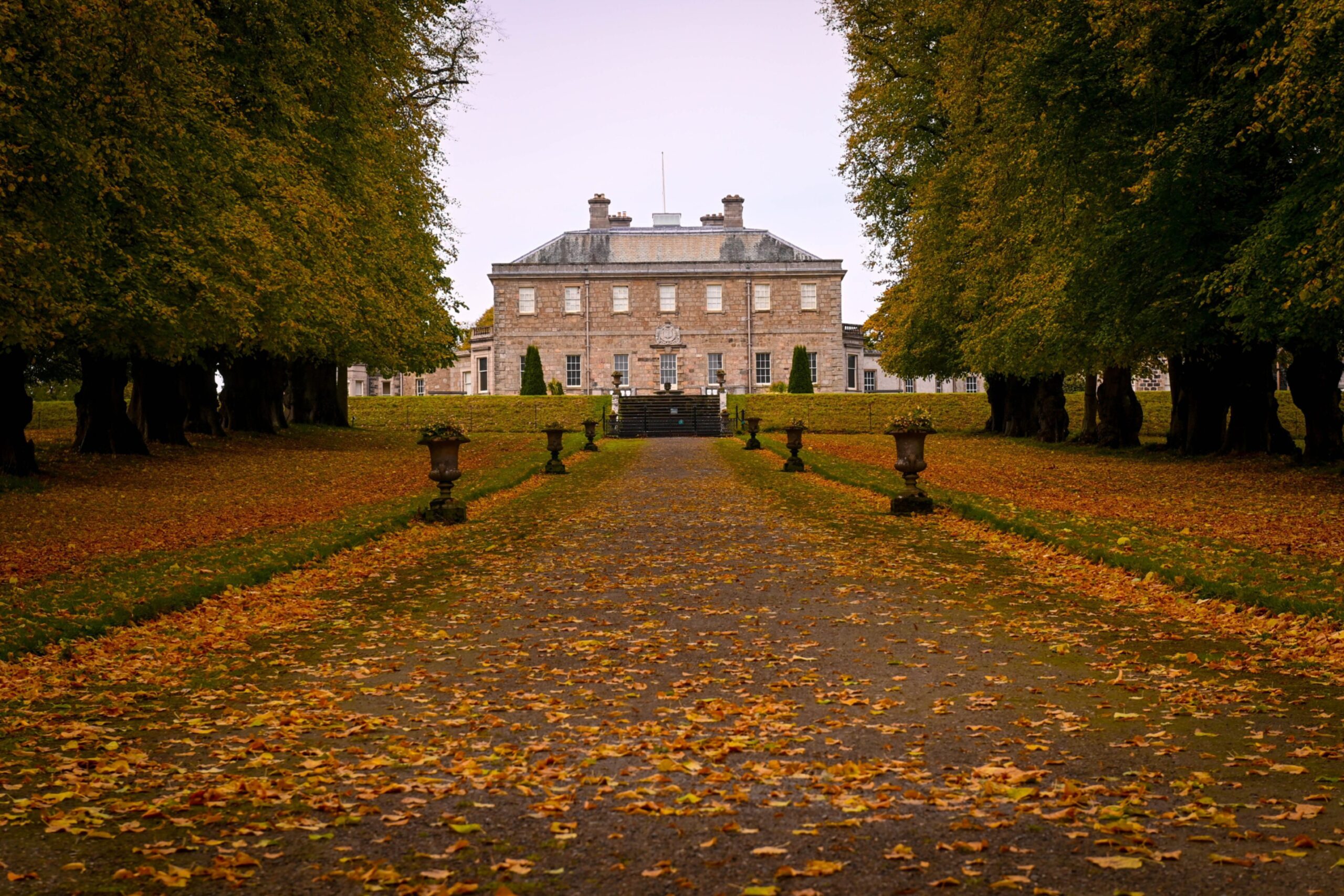 The tree-lined avenue walk with autumn leaves on the ground up to Haddo House, Ellon. Pictured is Haddo House in autumn. Sunday 13th October 2024. Image: Darrell Benns/DC Thomson.