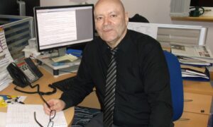 Neil Macphail at his desk in The P&J office in Inverness in 2015. Image: DC Thomson