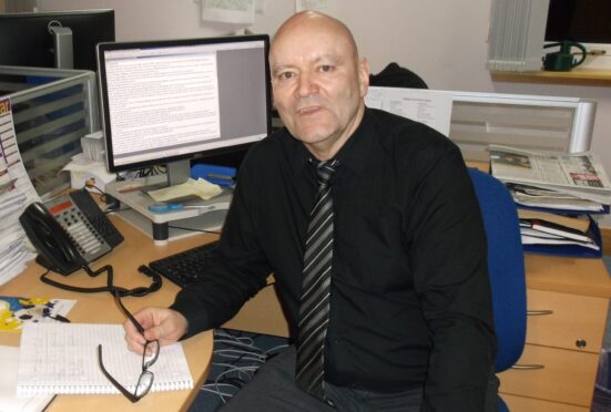 Neil Macphail at his desk in The P&J office in Inverness in 2015. Image: DC Thomson