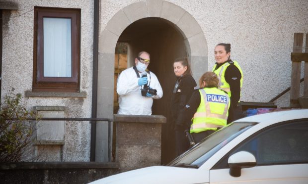 Police and forensics outside a property at Munro Place. Image: Tyler McNeil