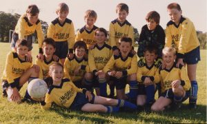 Champion Street 1990 - The Provost Watt Albion team is in safe hands as the team's only female player Wendy Norrie holds on to the ball. The rest are (back, from left): Michael Murray, Robert Smith, Andrew Campbell, Michael Dunn, Shaun Angus and John Chambers. Front: Richard Smith, Darren Norrie, Paul Gray, Stephen Pratt, Barry Robb, Lee Mathieson, and Michael Boyd. Image: DC Thomson.