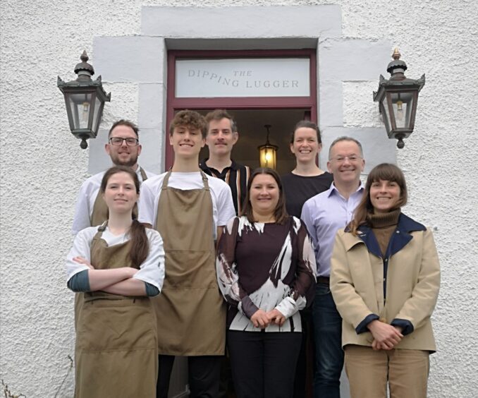 Staff of The Dipping Lugger outside the door of the restaurant.