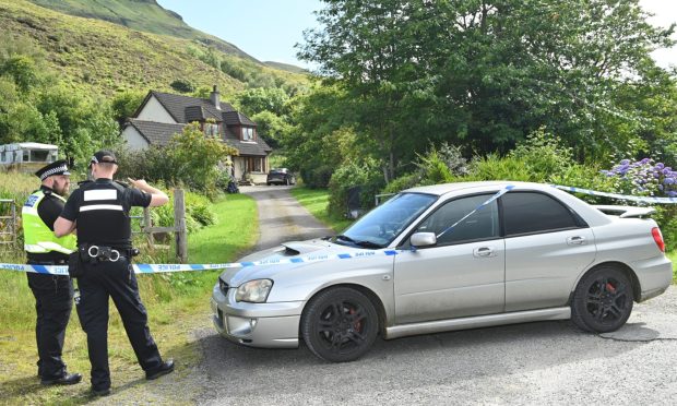 Finlay MacDonald's car is taped off by police outside the scene of the shooting in Dornie.