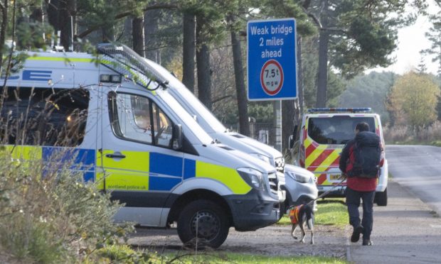 Coastguard, police and RAF S&R van along with a search dog at Lossiemouth woods.