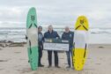 Craig Walker present's one of our P&J 275 Community Fund Charities, SurfABLE Scotland, their final cheque. Pictured is Craig, Chief Executive Glyn Morris (no hat) and deputy Chief Executive is Kev Anderson. Image: Jason Hedges/DC Thomson.