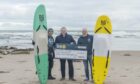 Craig Walker present's one of our P&J 275 Community Fund Charities, SurfABLE Scotland, their final cheque. Pictured is Craig, Chief Executive Glyn Morris (no hat) and deputy Chief Executive is Kev Anderson. Image: Jason Hedges/DC Thomson.