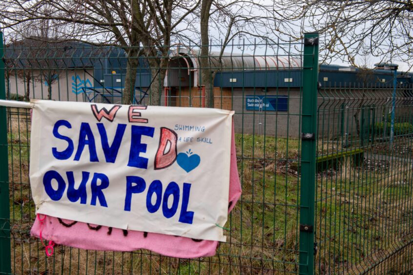 A sign that used to say "save our poll" that has since been modified to say "We saved our pool" outside Bucksburn Swimming Pool