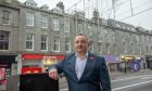 Cater Group operations manager photographed outside their Union Street flats above the Santander bank.