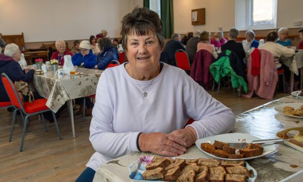 Helen Reid smiling at the camera for the coffee morning