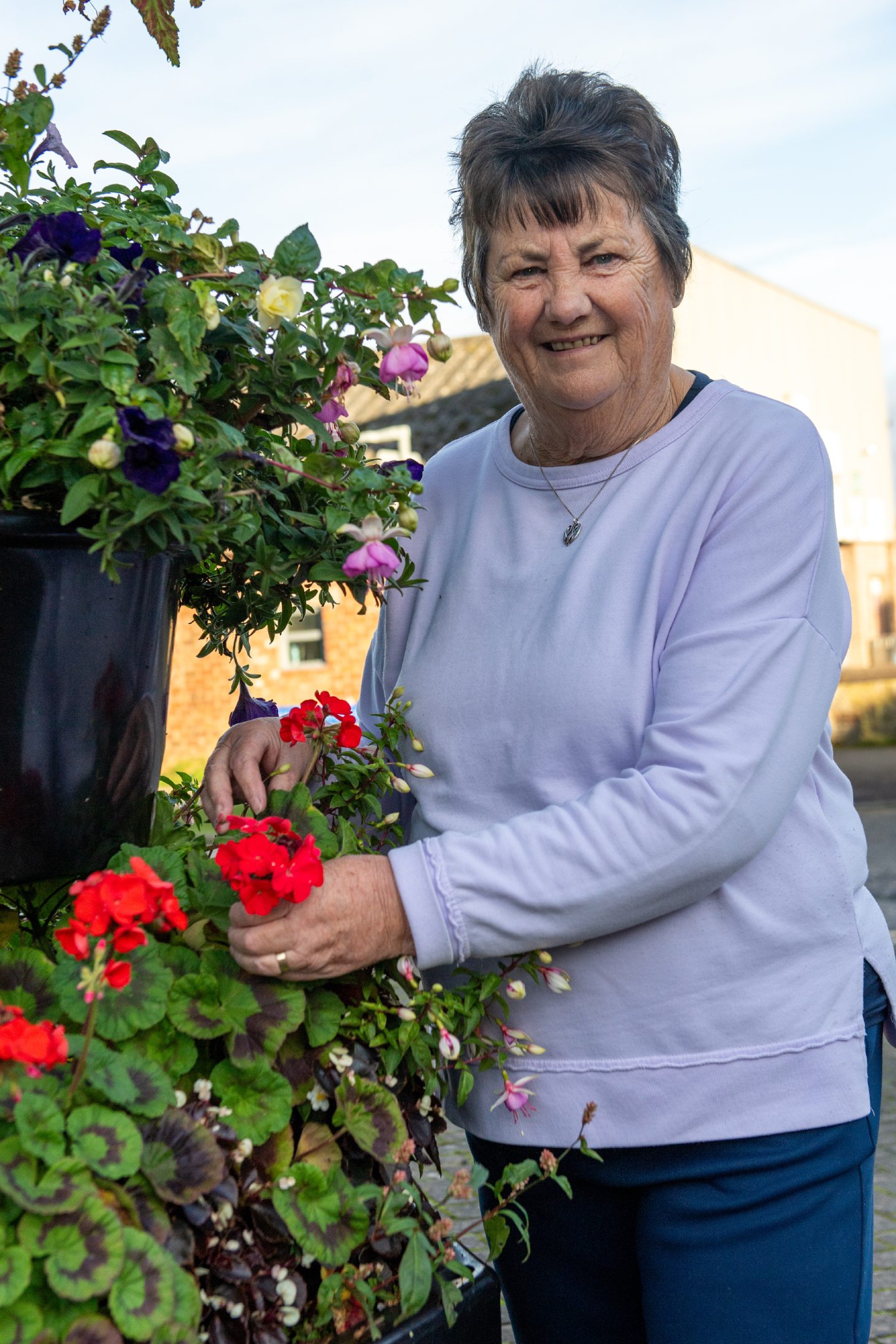 Helen Reid with one of the tiered flower arrangements she helps put together. 