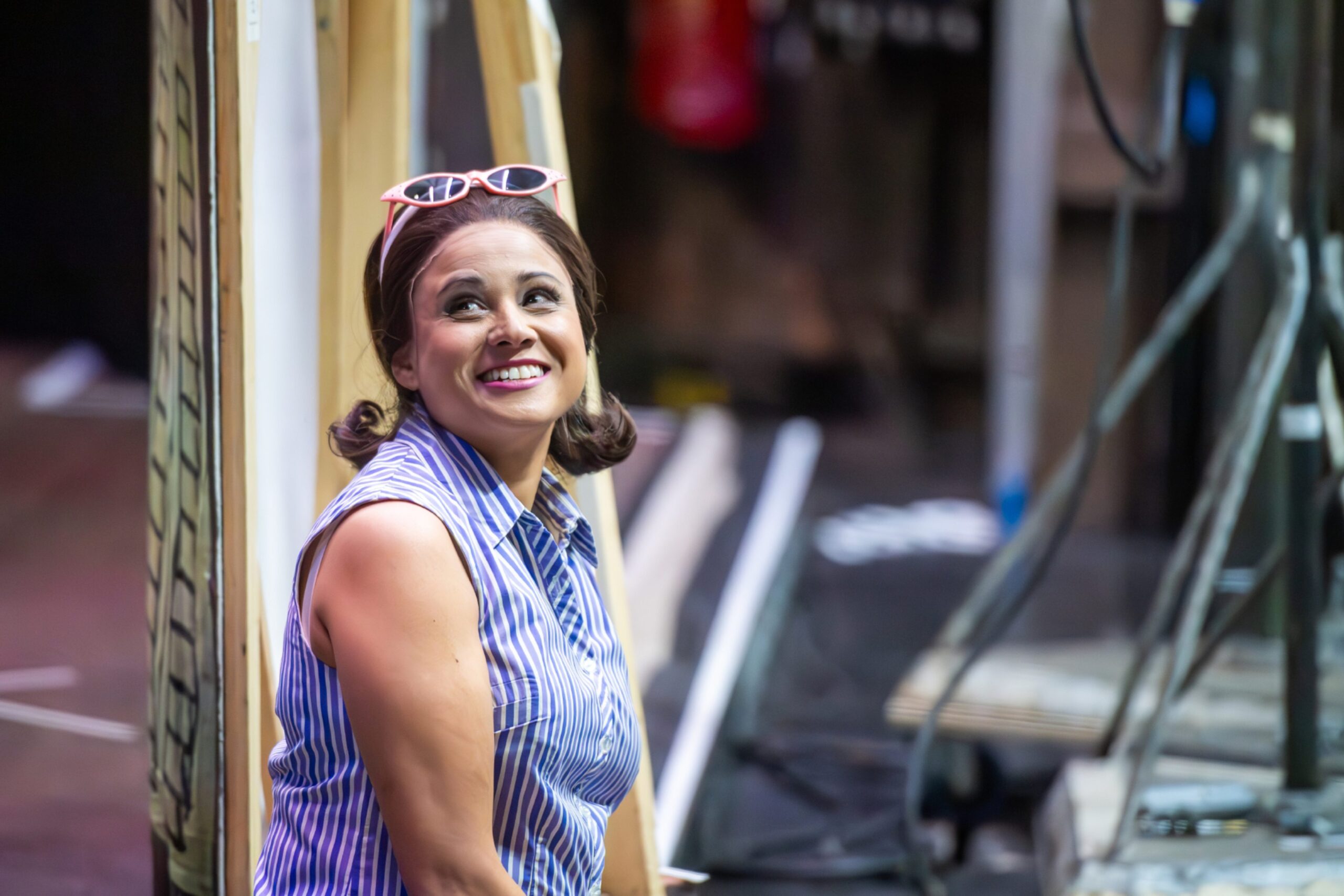 Stacey Alleaume smiling behind the stage at HMT