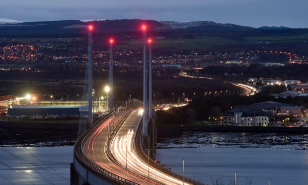 Kessock Bridge in the dark with white and red stream lights showing passing cars