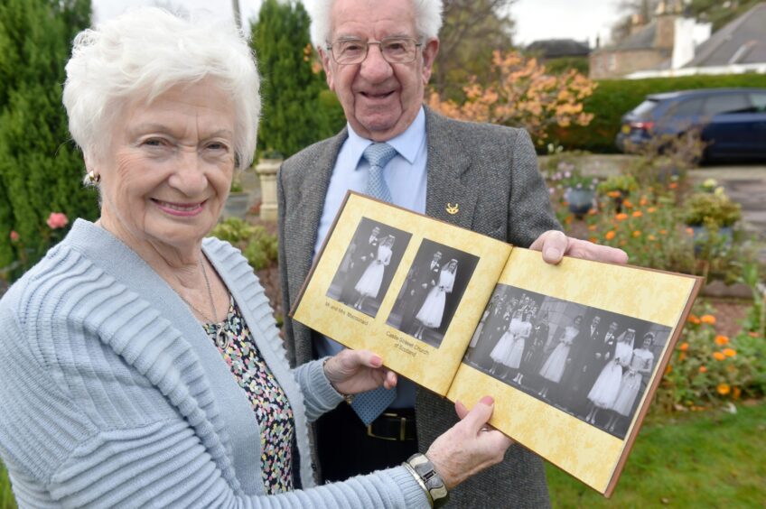 Hamish and Joan with their wedding album