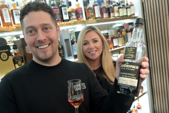 Beau Wallace with his partner Jane Manson, owners of Grand Drams on Old Edinburgh Road, Inverness with some of their extensive whisky collections. Image:
Sandy McCook/DC Thomson.