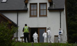 Police and forensics experts at the scene of the shooting at a property in Teangue.