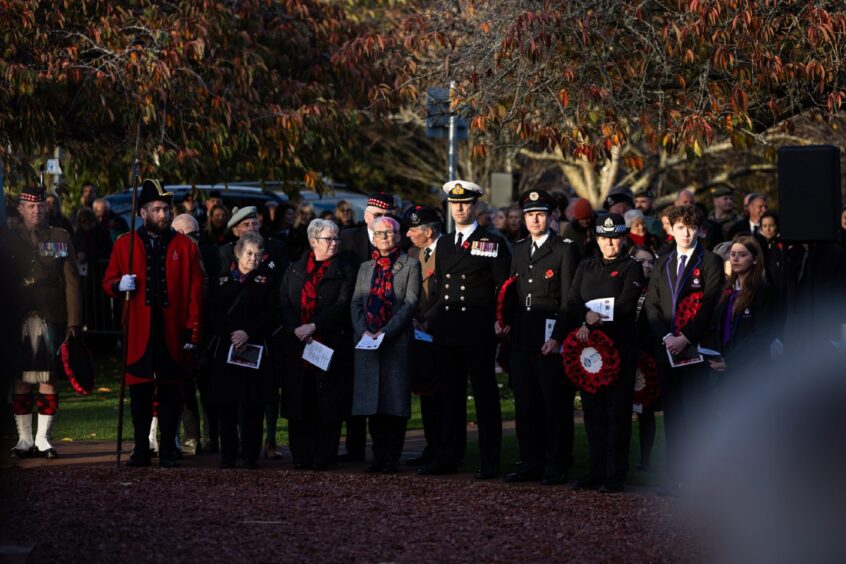 People stand for silence in Inverness