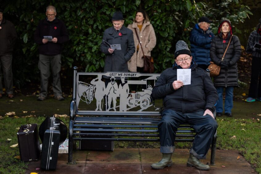 Man sitting on memorial bench 