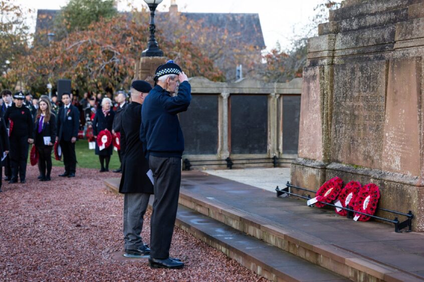 Men lay wreaths at war memorial 