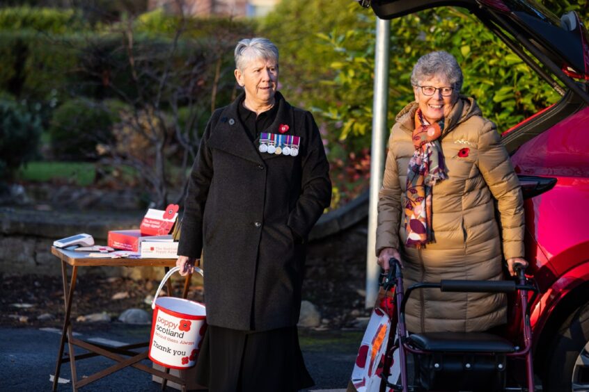 Volunteers with charity buckets for Poppy Scotland 