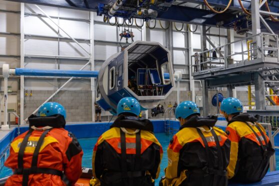 Getting ready to simulate a helicopter crash escape in the North Sea at 3t in Dyce. Image: by Scott Baxter / DC Thomson