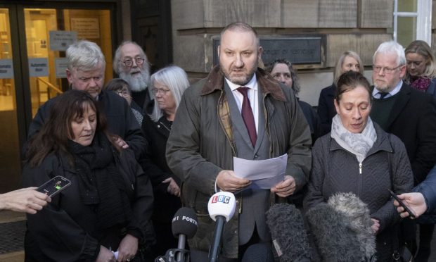 Detective Inspector Richard Baird, centre, reads the MacKinnon family statement on behalf of sisters Ann McDonnell, left, and Christine Scally, right. Image: Alan Simpson