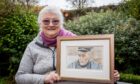 Julie Allan, with a painting by Abigail Fielder-Heim of her dad, Raasay road builder, Calum MacLeod. Image: Steve Brown/DC Thomson