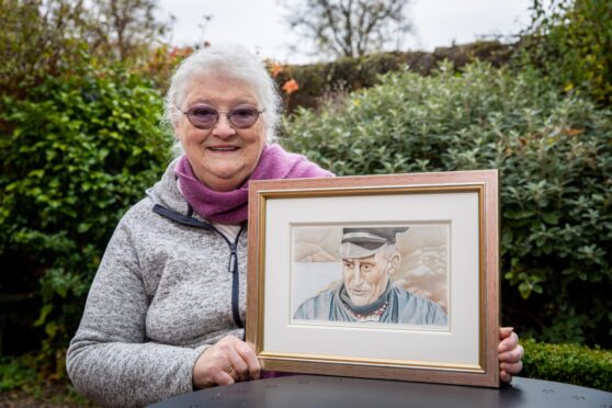 Julie Allan, with a painting by Abigail Fielder-Heim of her dad, Raasay road builder, Calum MacLeod. Image: Steve Brown/DC Thomson