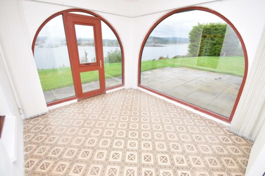 Sunroom with large arched windows.