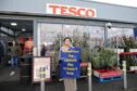 Woman protesting outside Tesco in Stornoway, Lewis, as it opens on Sunday for the first time.