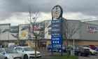 Half the blue B&M sign is missing after round sign breaks off.