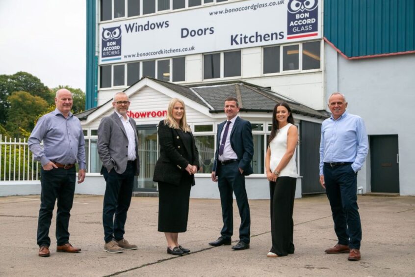 Colin Kinghorn, Neil Wilson, Michelle Kinghorn, Ian McDonald, Danielle McAnespie and Martin Allan outside Bon Accord Glass in Riverside Drive