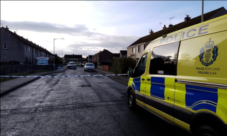 Police van sits in front of Police tape on Druid Road, Inverness.