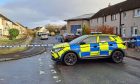 Police car blocks off part of Druid Road in Inverness.