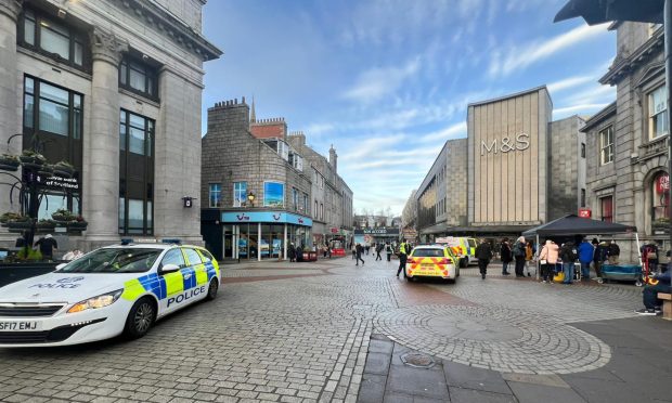 Police vehicles on St Nicholas Street in Aberdeen.