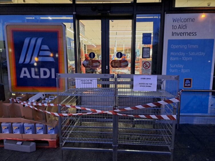 Main entrance blocked off by shelving units.