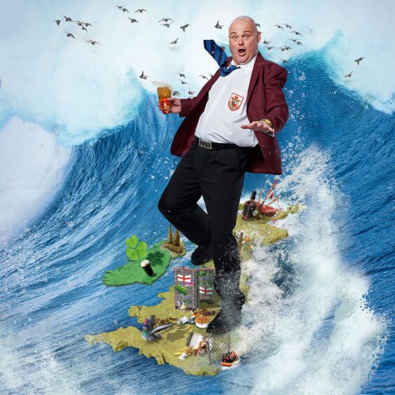 Al Murray on land as a wave crashed behind him.