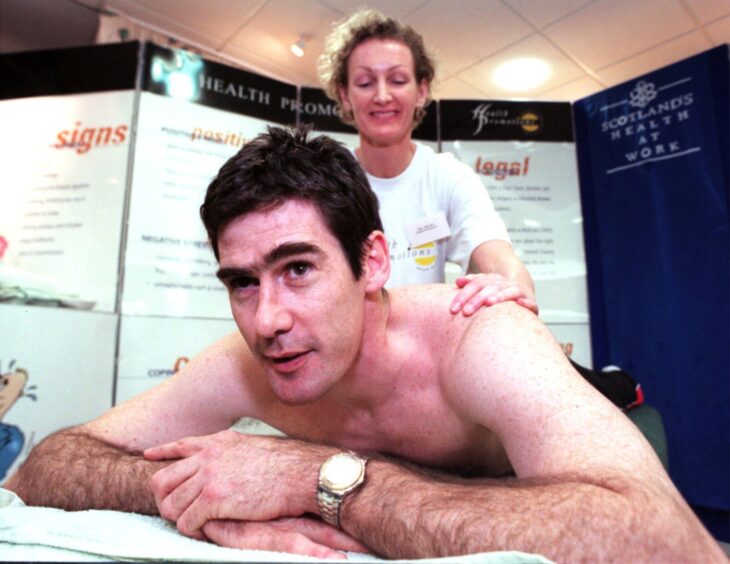 Aberdeen FC forward Mike Newell enjoys a massage from Mary Malcolm as part of a Health at Work event organised by Health Promotions for Shell.