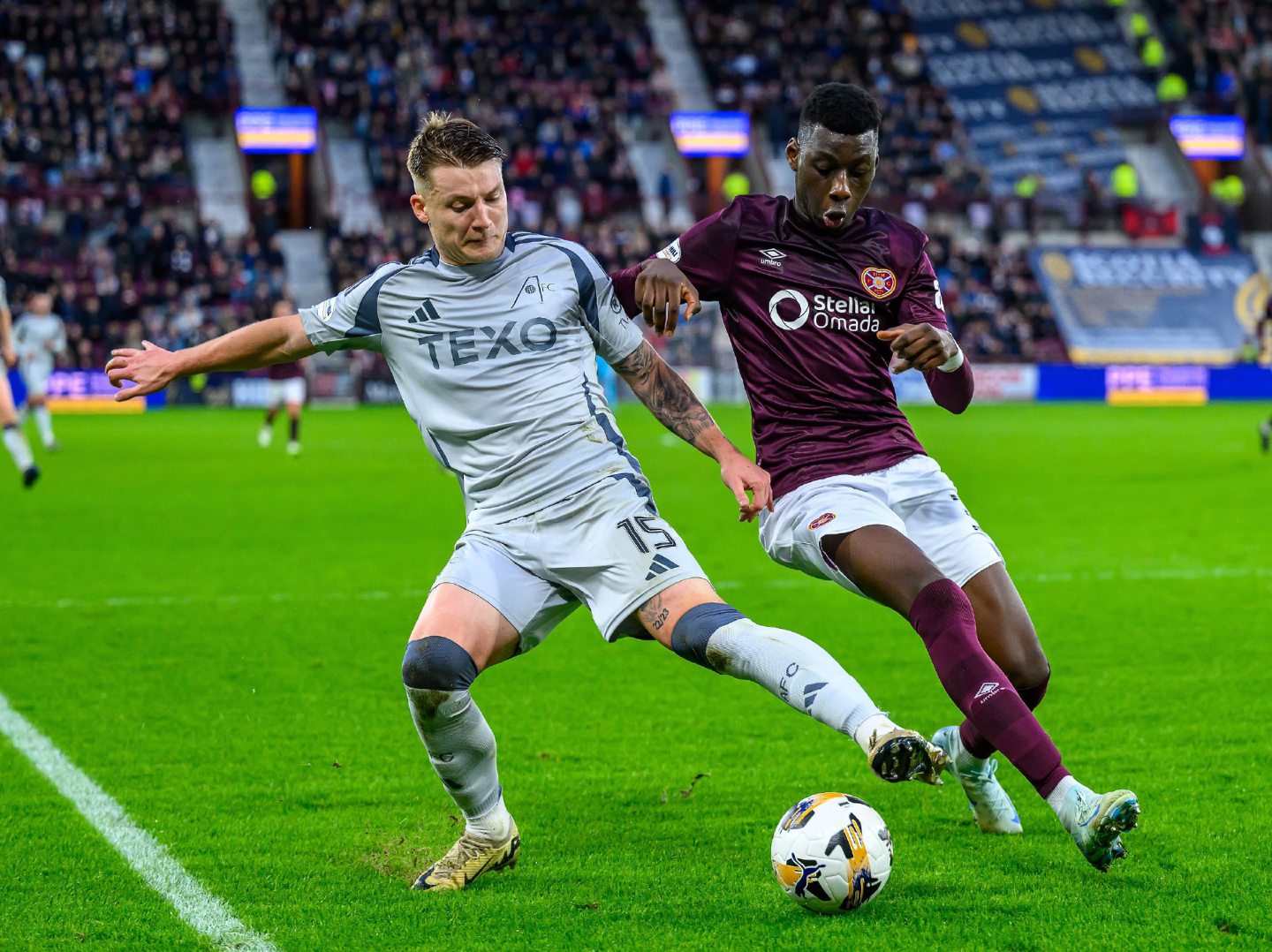 James McGarry of Aberdeen tackles Musa Drammeh of Hearts. Image: Shutterstock 