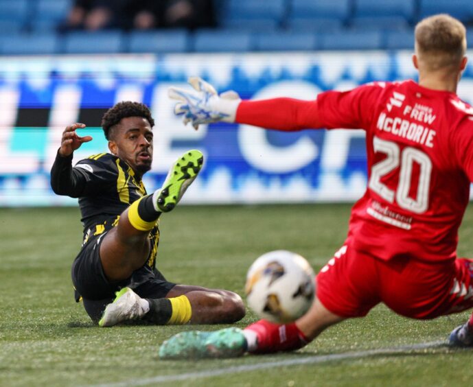 Aberdeen's Duk slides in for a challenge with the keeper during the 4-0 loss to Kilmarnock at Rugby Park.