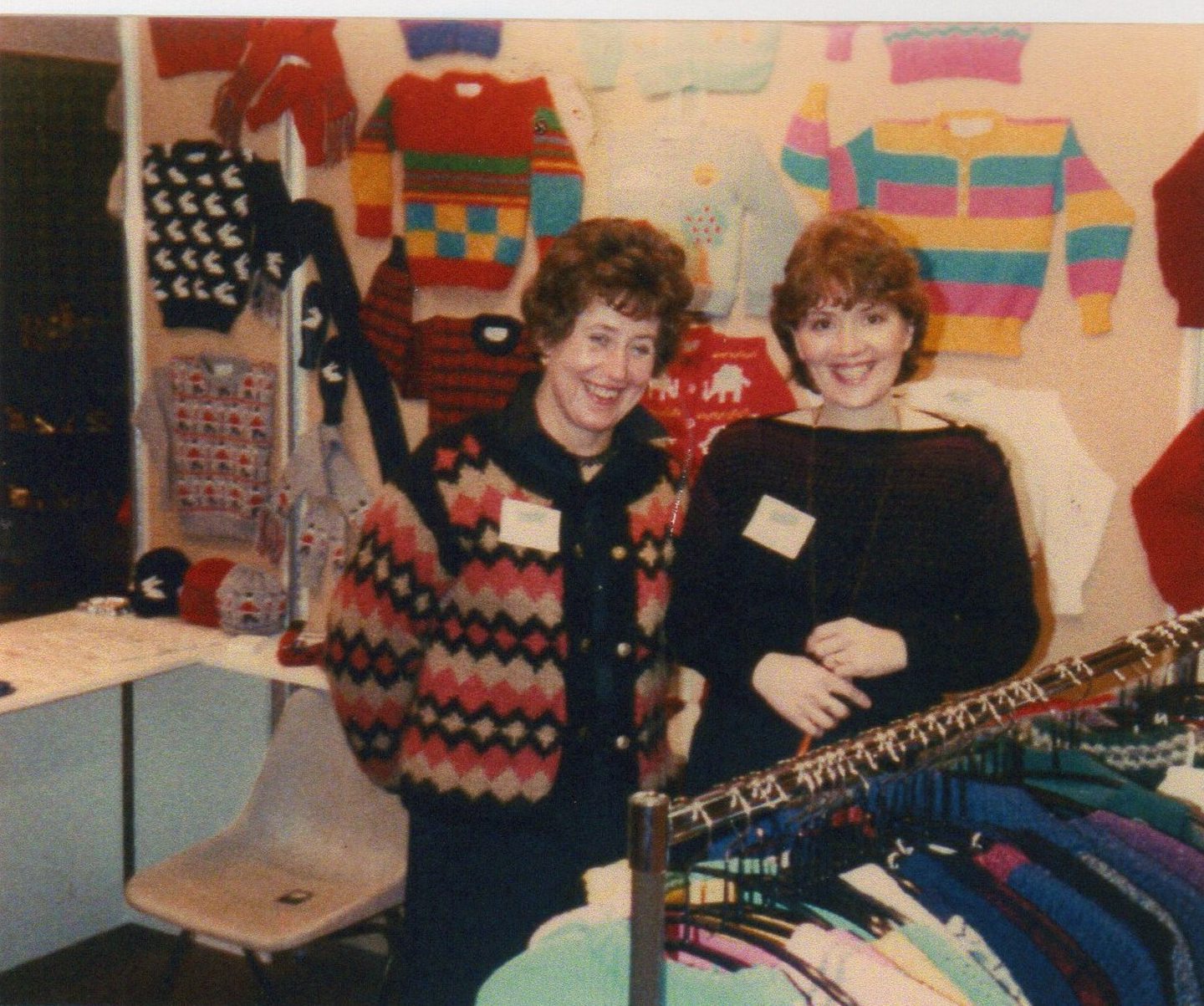 Sandra Towrie and Elspeth Sinclair at a trade fair in Aviemore, surrounded by brightly-coloured jumpers.