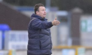 Inverness head coach Scott Kellacher points to his players from the sidelines.