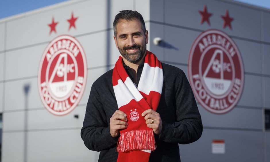 New Aberdeen FC head of recruitment Nuno de Almeida pictured with a red and white scarf at the club's Cormack Park training facility. 