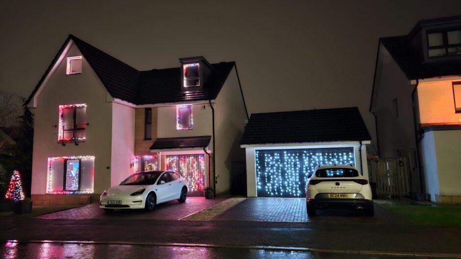 House covered in multi-coloured lights.