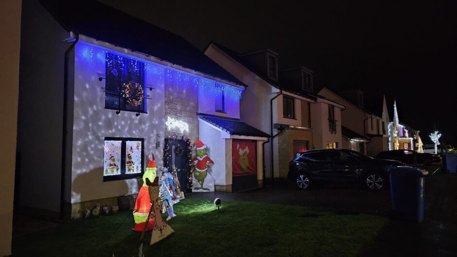 House with inflatable Gringe outside.