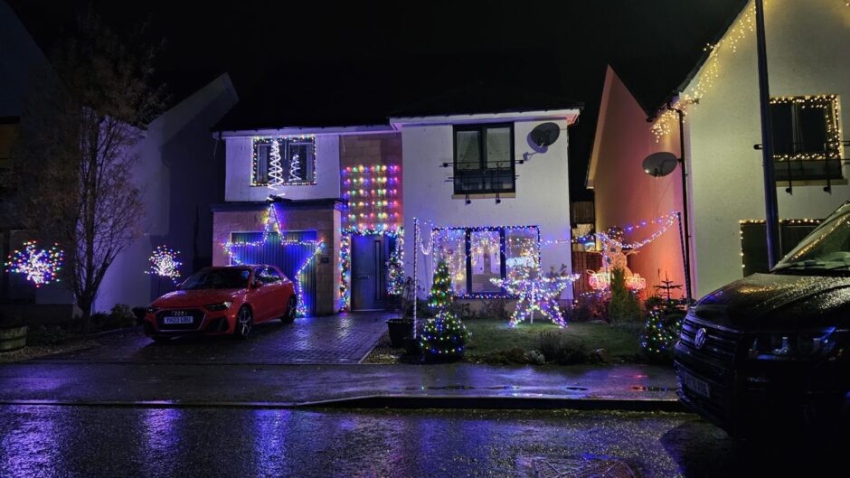 Home covered in multi-coloured Christmas lights.