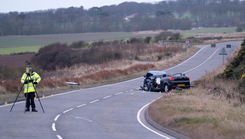 Police officer investigates scene of the crash