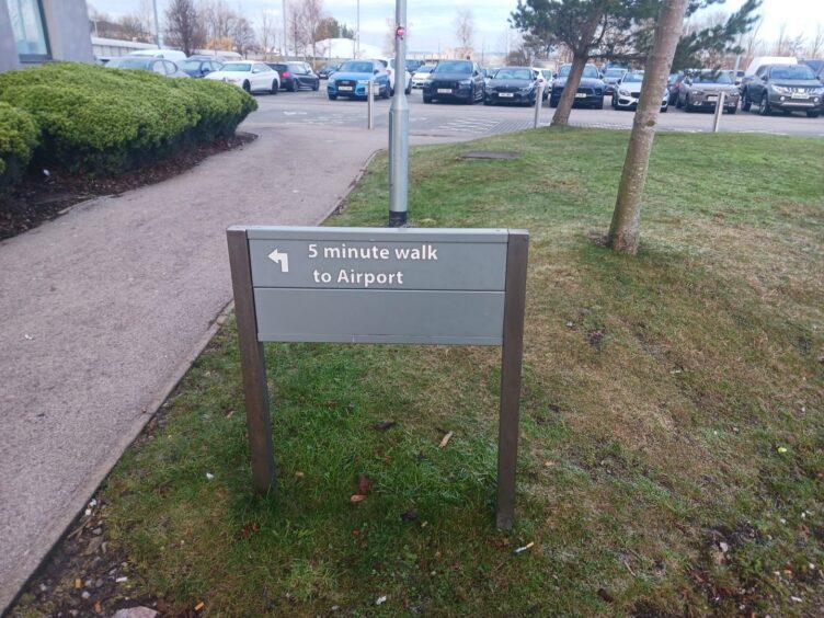 "5 minute walk to Airport" sign.