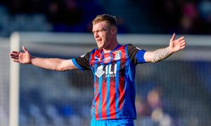 Inverness Caledonian Thistle striker and assistant manager Billy Mckay is pictured here during a match with his hands aloft, looking for a pass from a team-mate.