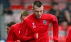 Ross County's on-loan defender from Barnsley, Kacper Lopata, is pictured during a recent warm-up session, leading from the front.