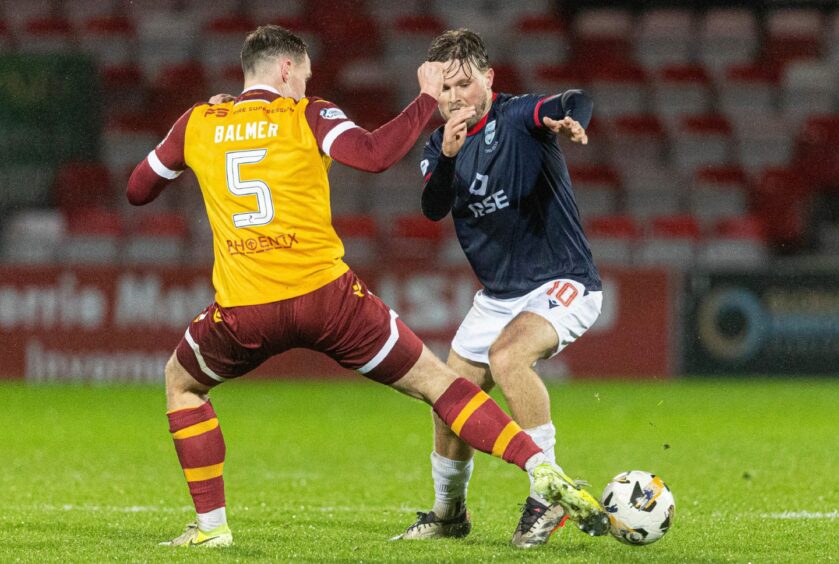 Ross County midfielder Noah Chilvers takes on Motherwell's Kofi Balmer in the Dingwall team's 2-1 Scottish Premiership win on November 23, 2024 at the Global Energy Stadium. 